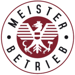 Kreisförmiges Logo mit dem Schriftzug „MEISTER BETRIEB“, das einen stilisierten, kastanienbraunen und weißen Adler mit Werkzeugen umgibt.