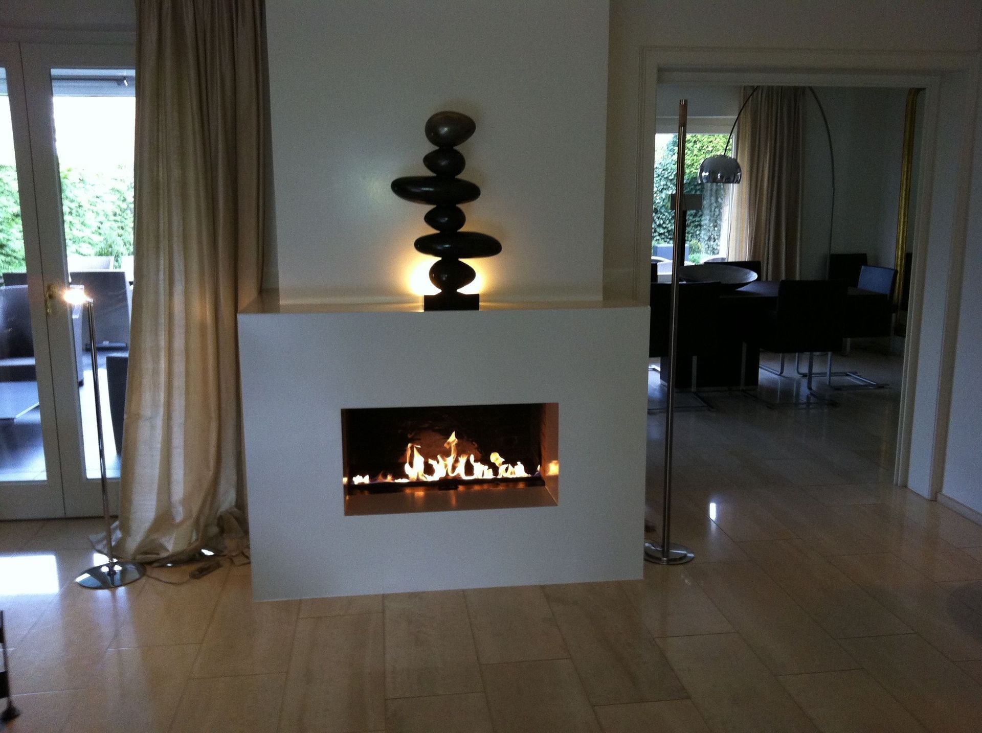 Ein Wohnzimmer mit Kamin und einer Skulptur an der Wand