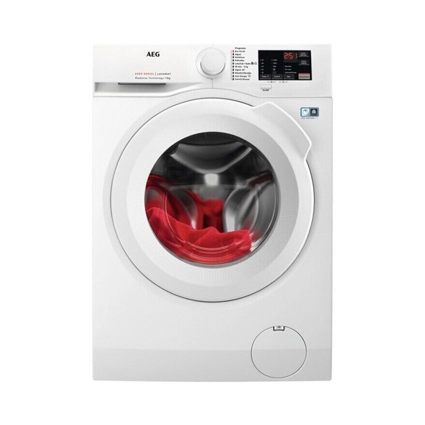 Una lavadora blanca con ropa roja dentro.