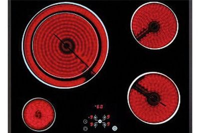 Un primer plano de un horno de estufa con círculos rojos sobre él.