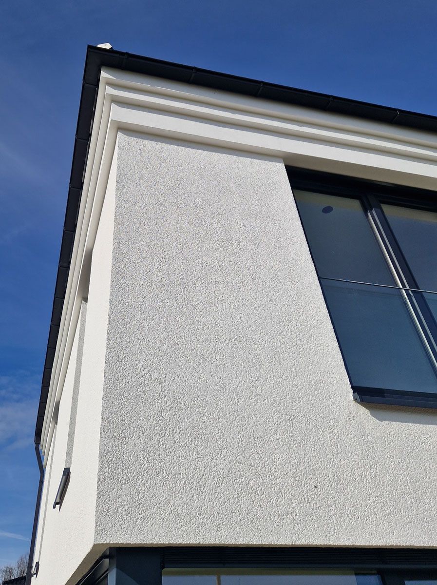 Ein weißes Gebäude mit einem blauen Himmel im Hintergrund