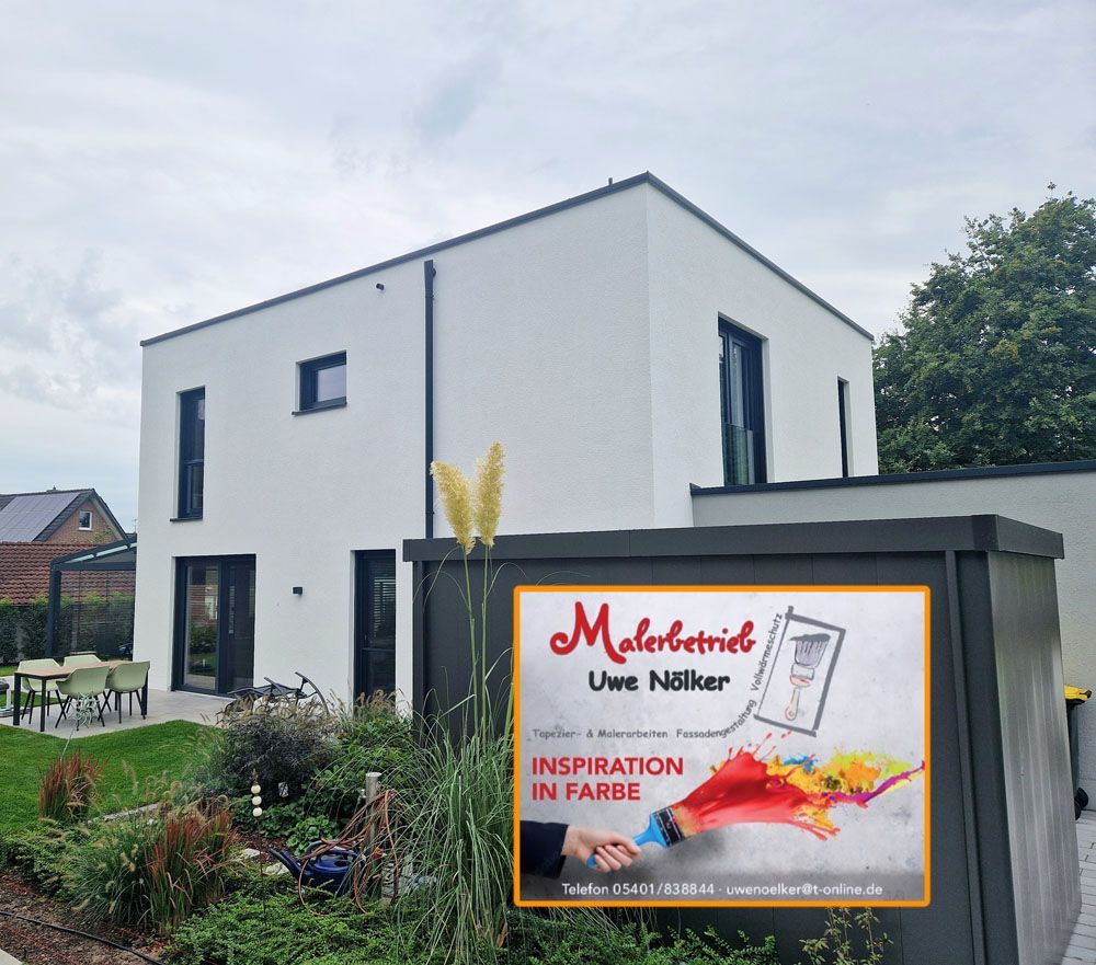 Ein weißes Haus mit einem Schild davor, auf dem steht „Malerbetrieb“