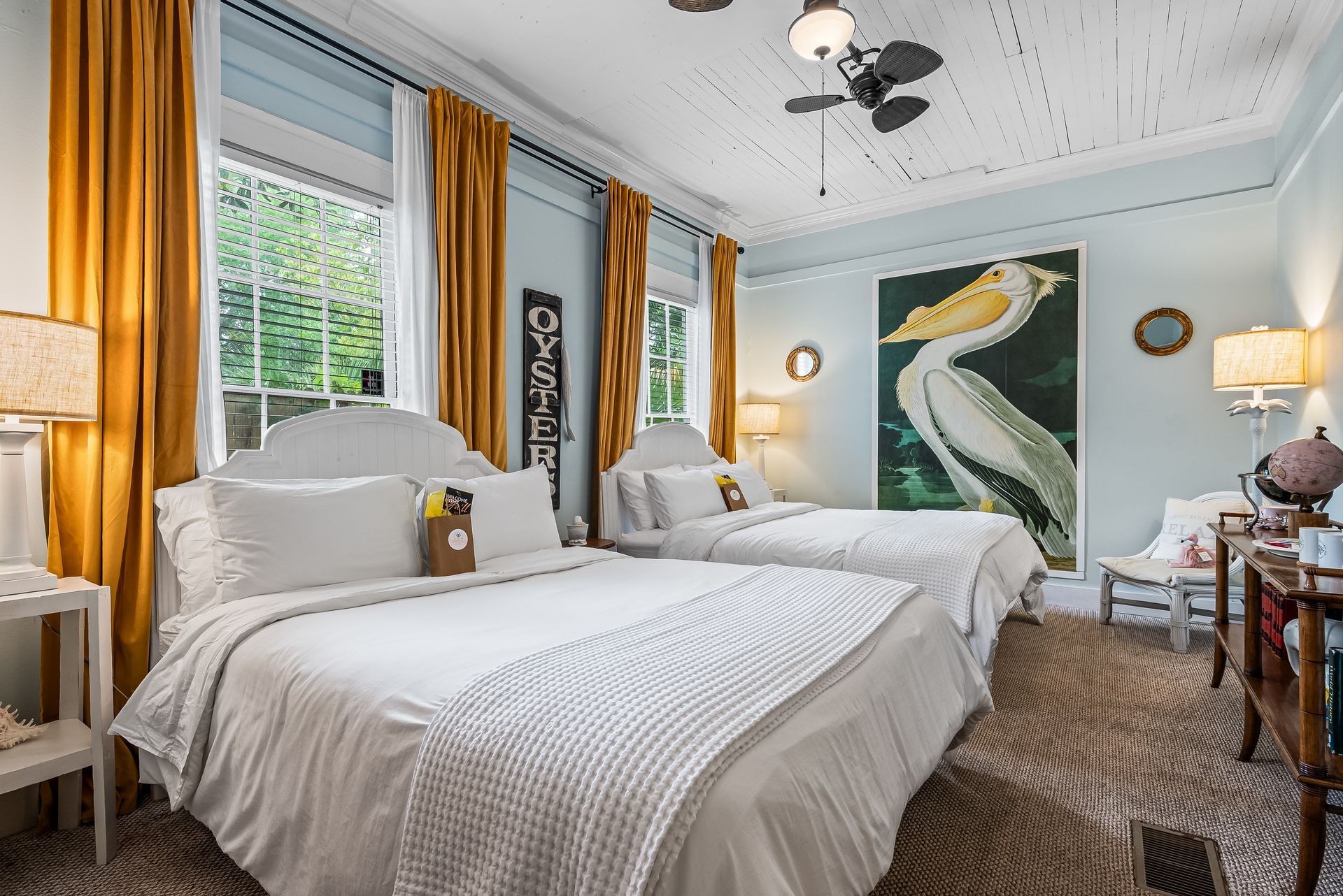 Captains Quarters two Queen beds with vintage decor and vintage art mural