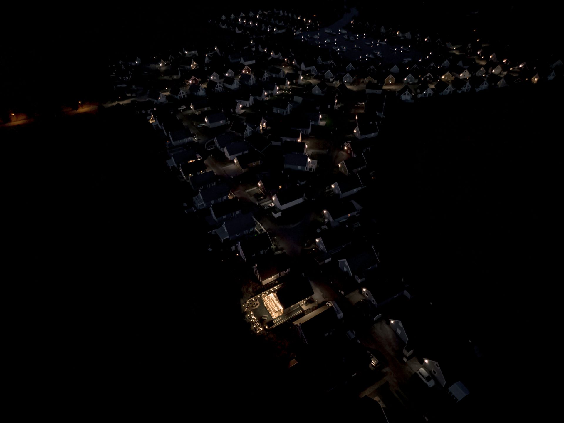 Hafendorf Zerpenschleuse lit up at night, seen from above