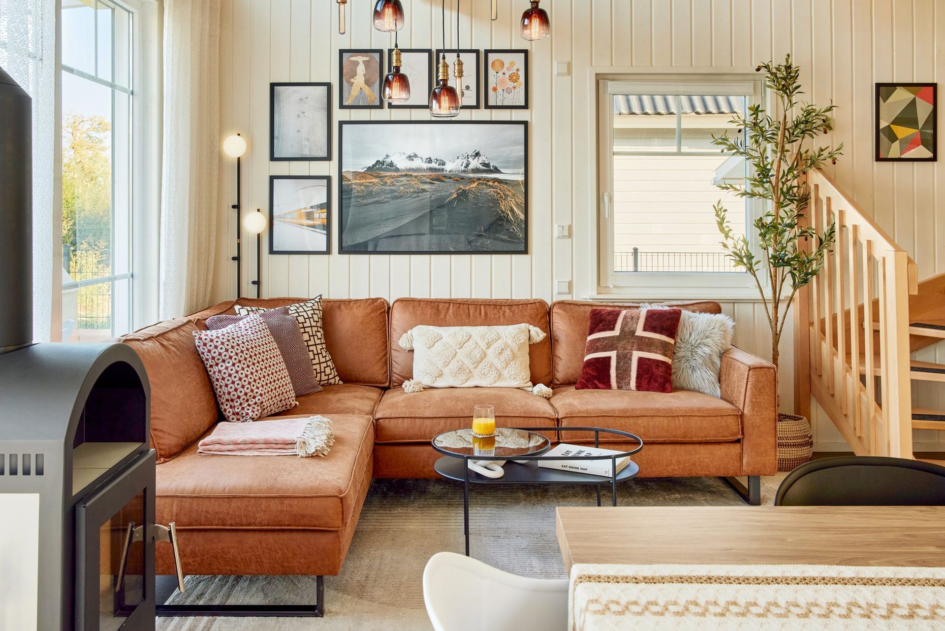 Cognac leather sofa corner with framed art on the wall
