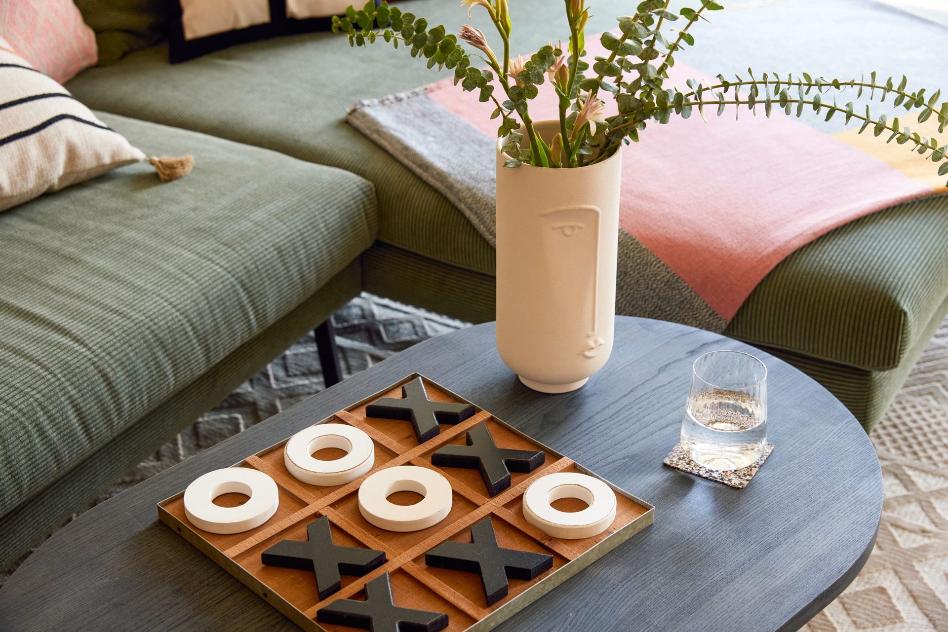 Green sofa with a coffee table and a board game