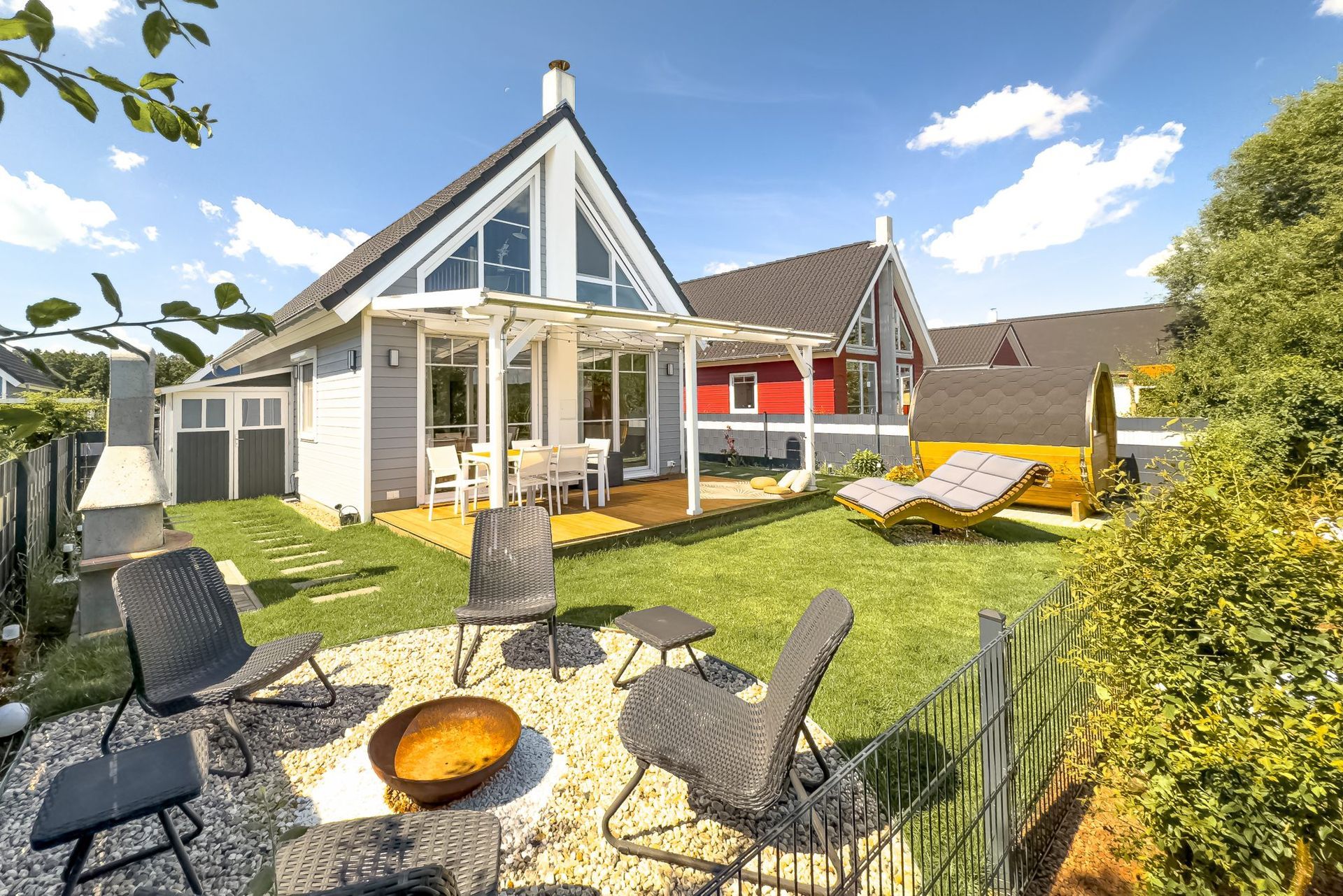 Terrace chairs and a fire bowl in front of the house