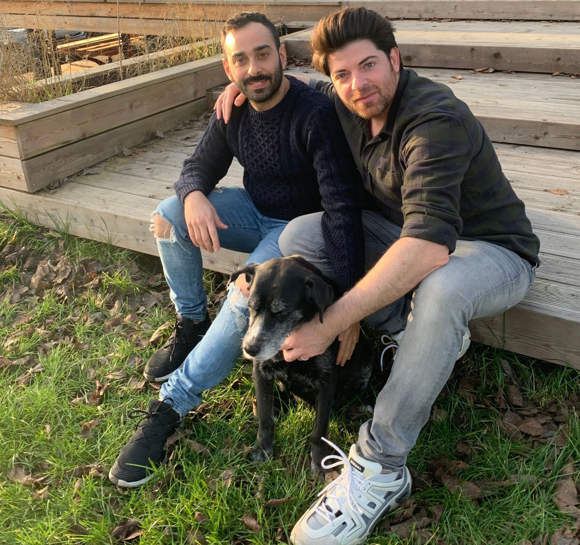 The hosts sitting on the garden steps with their dog