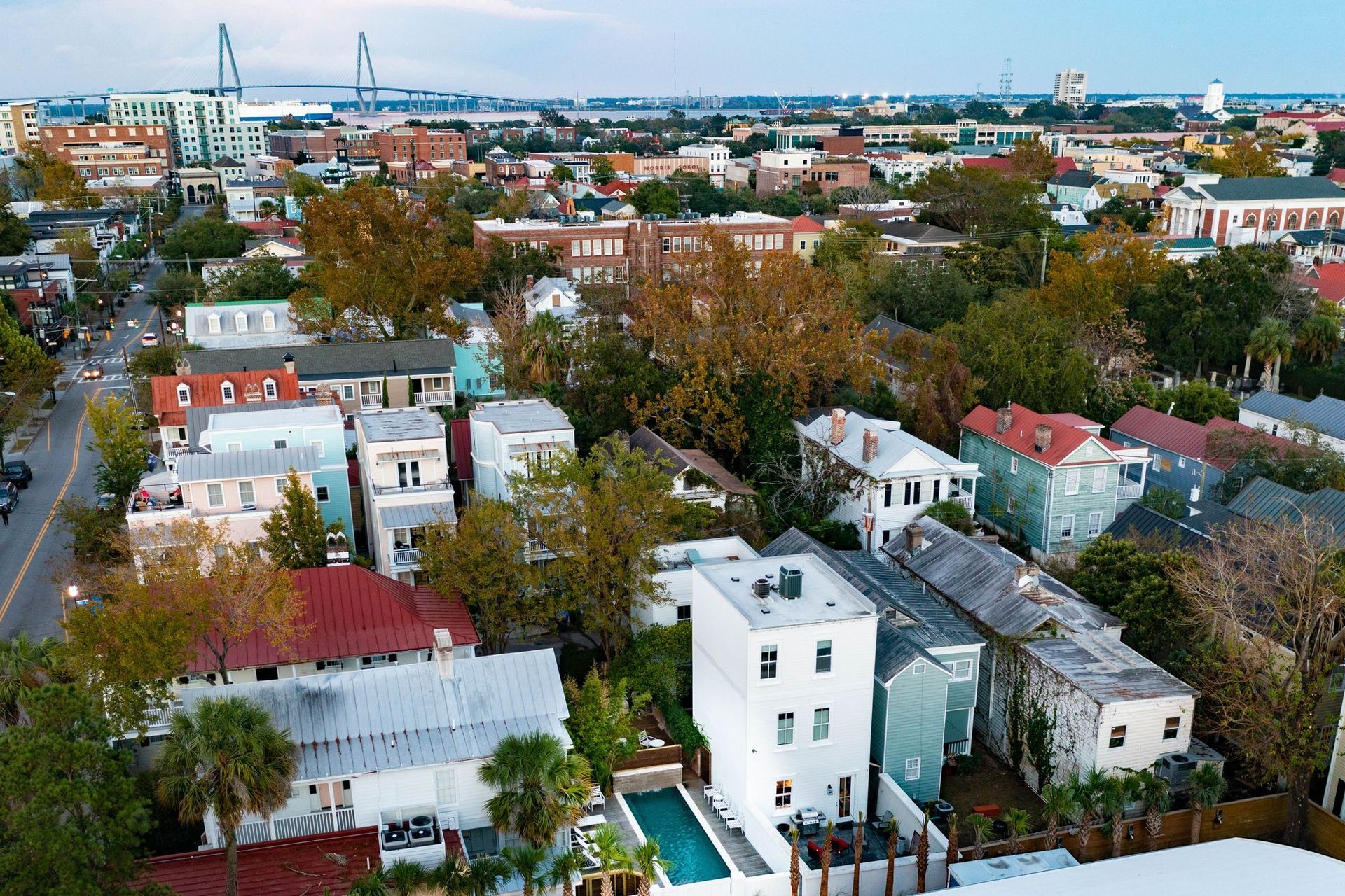 An aerial view of a city with a white building in the middle
