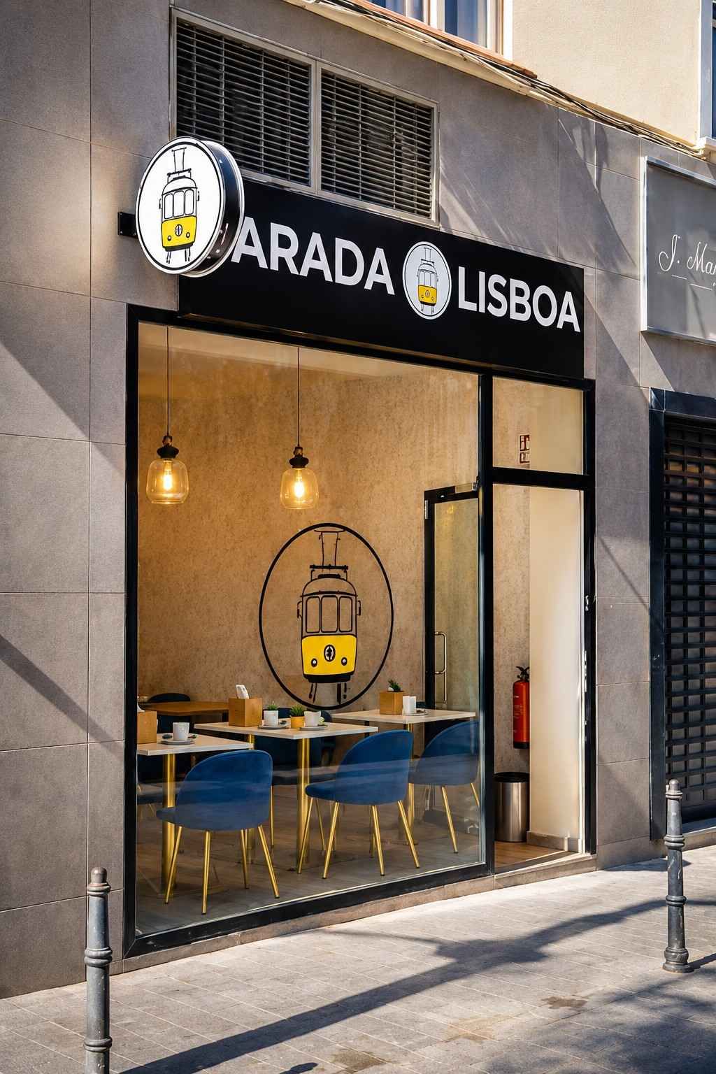 Exterior de la cafetería Arada Lisboa con puerta abierta, sillas azules y luces colgantes cálidas.