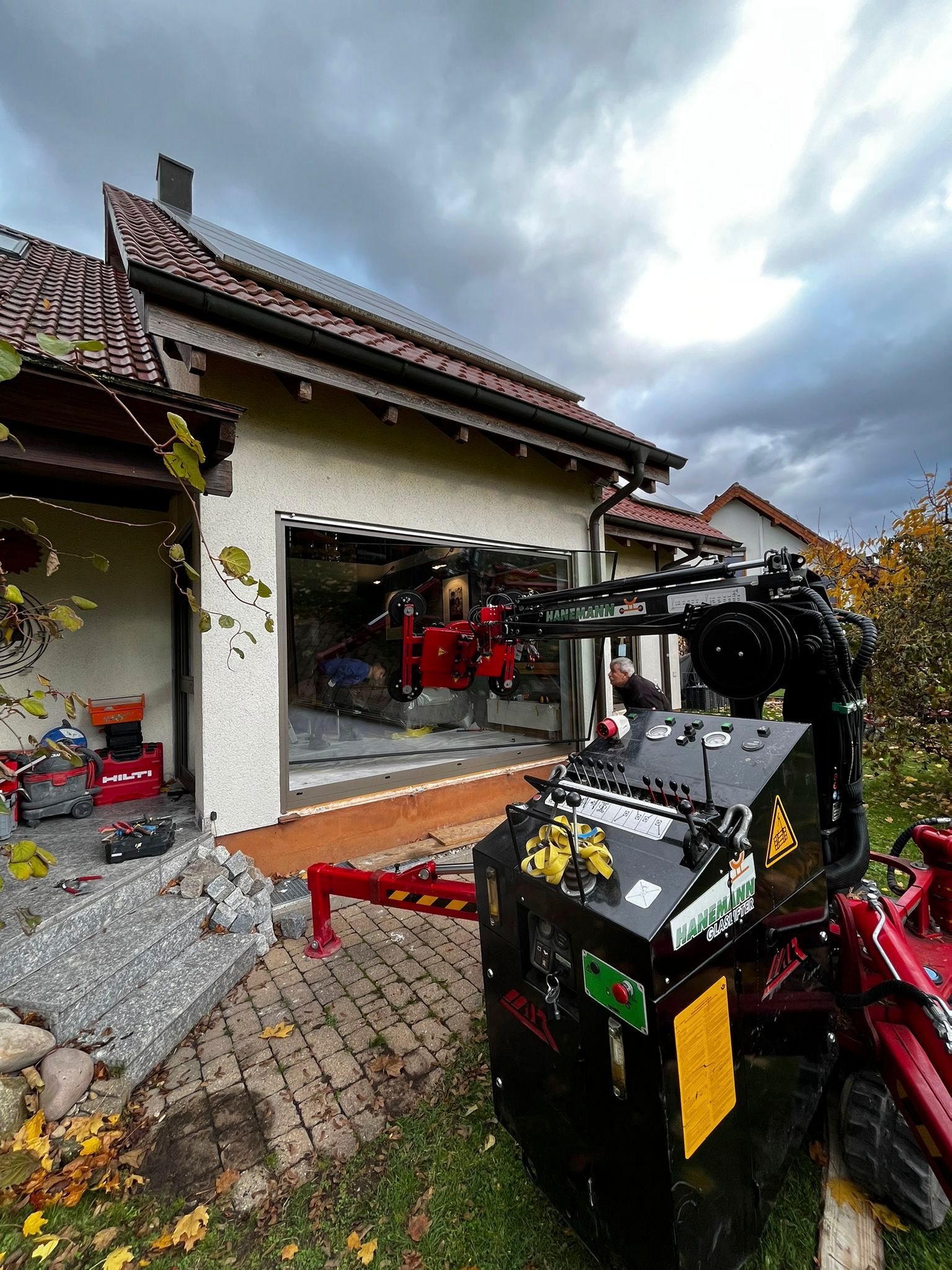 Vor einem Haus steht eine große Maschine.