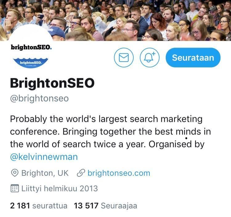 BrightonSEO:n Twitter-profiilin otsikko ja bio, sininen seurantapainike ja konferenssin yleisöbanneri