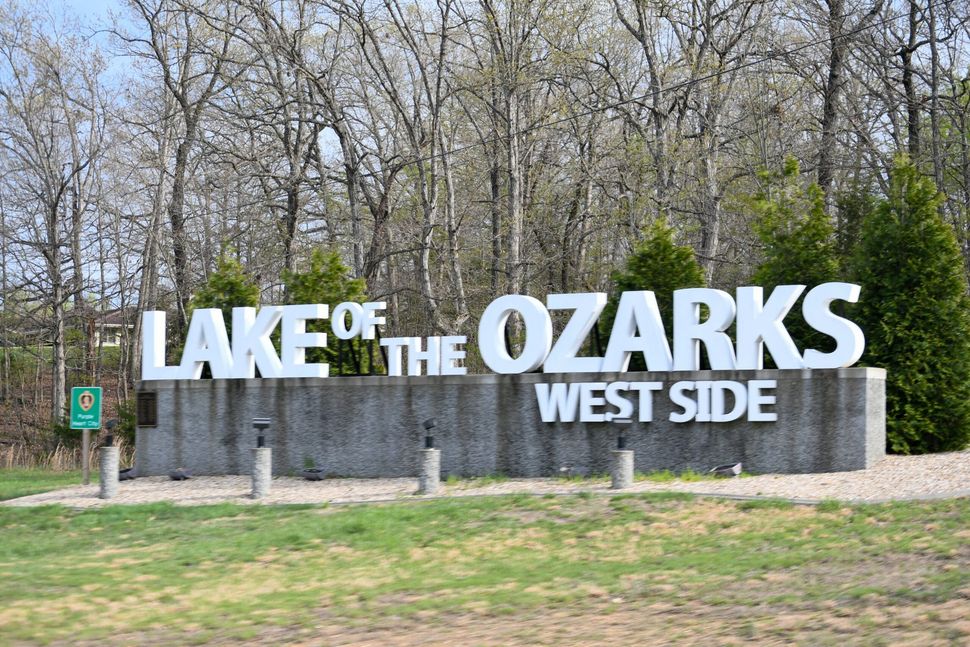 A large sign that says lake of the ozarks west side