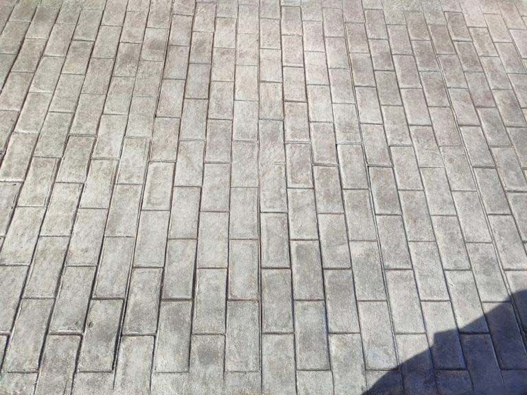 Pavimento de hormigón estampado con patrón de ladrillo rectangular.