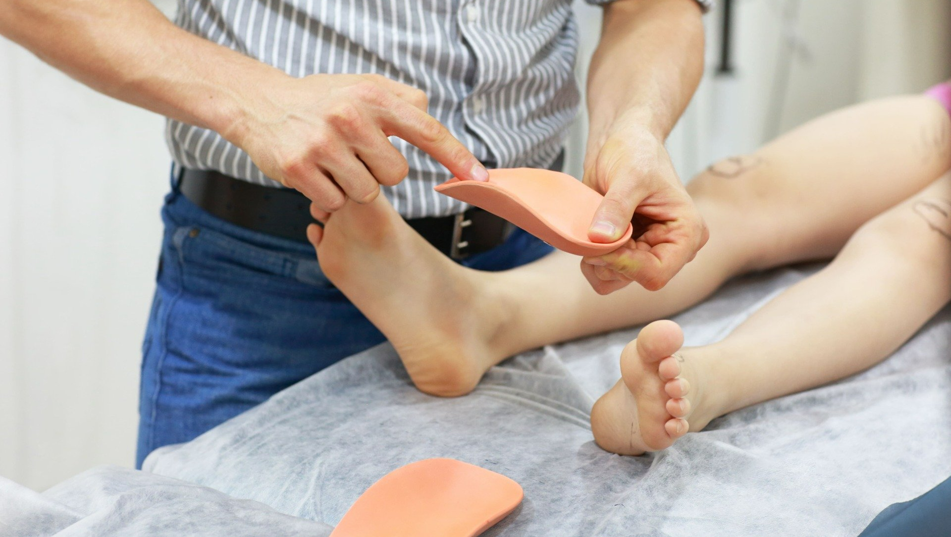 Podo-orthésiste expliquant des semelles orthopédiques