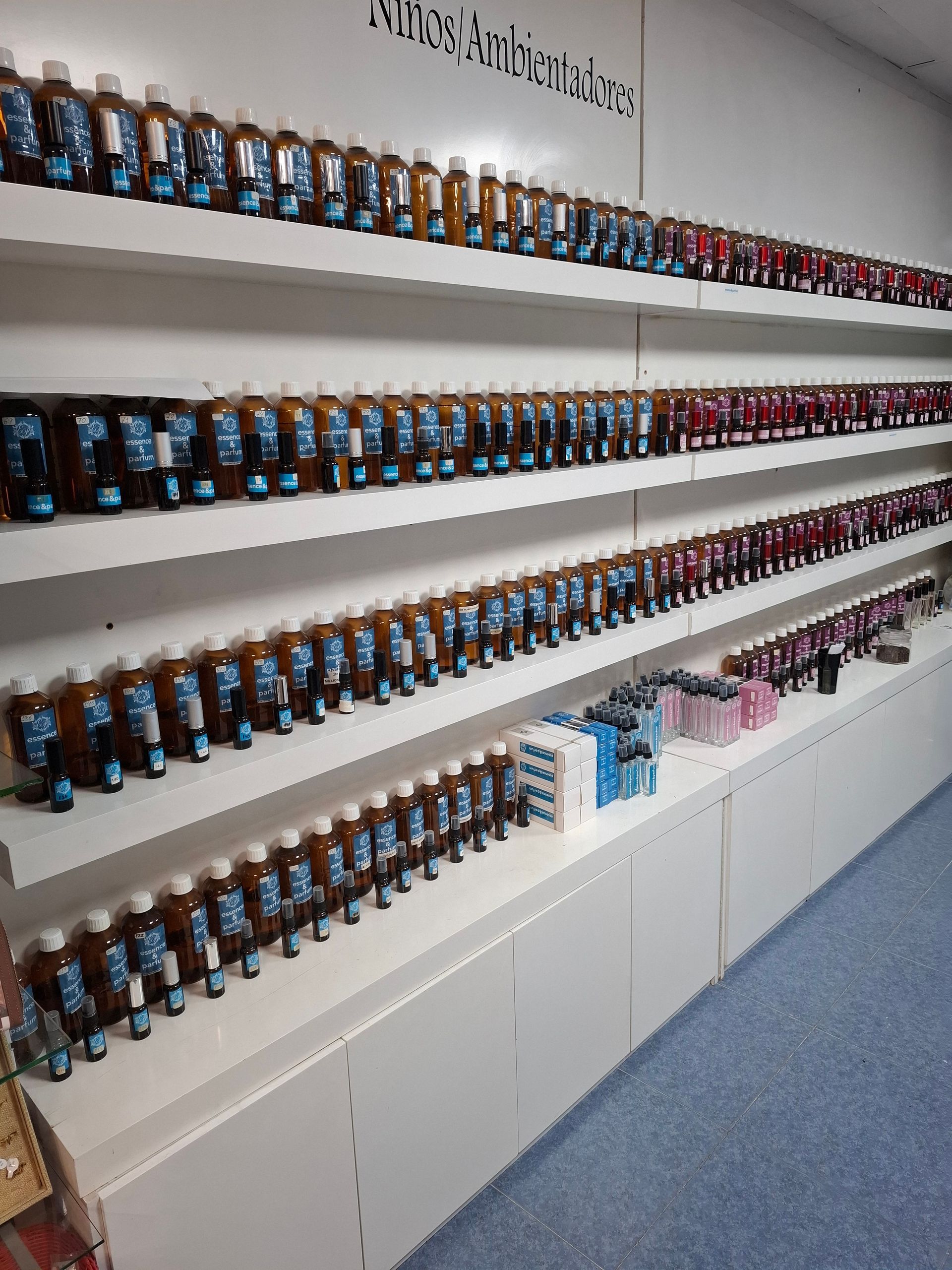 Estantes llenos de filas de botellas marrones en una tienda. También hay algunas cajas de productos en los estantes.