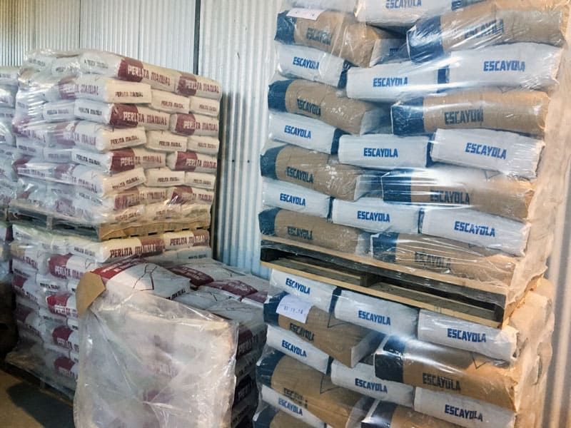 Un montón de bolsas están apiladas una encima de otra en un almacén.