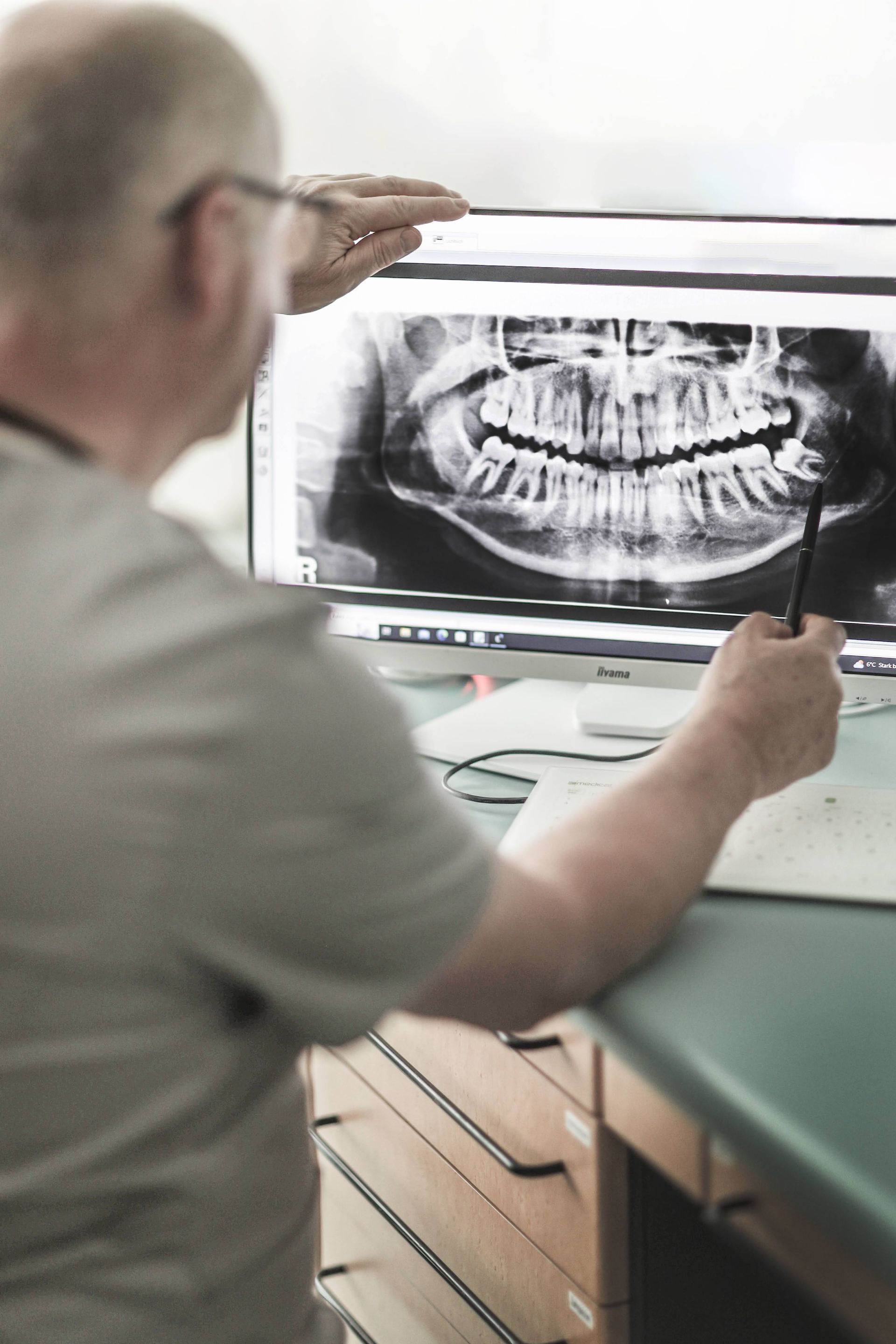 Zahnarzt Böwering zeigt auf ein Röntgenbild