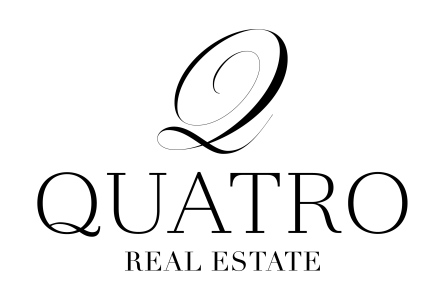 Logotipo de Quatro Real Estate en negro con una Q estilizada sobre el nombre de la empresa.