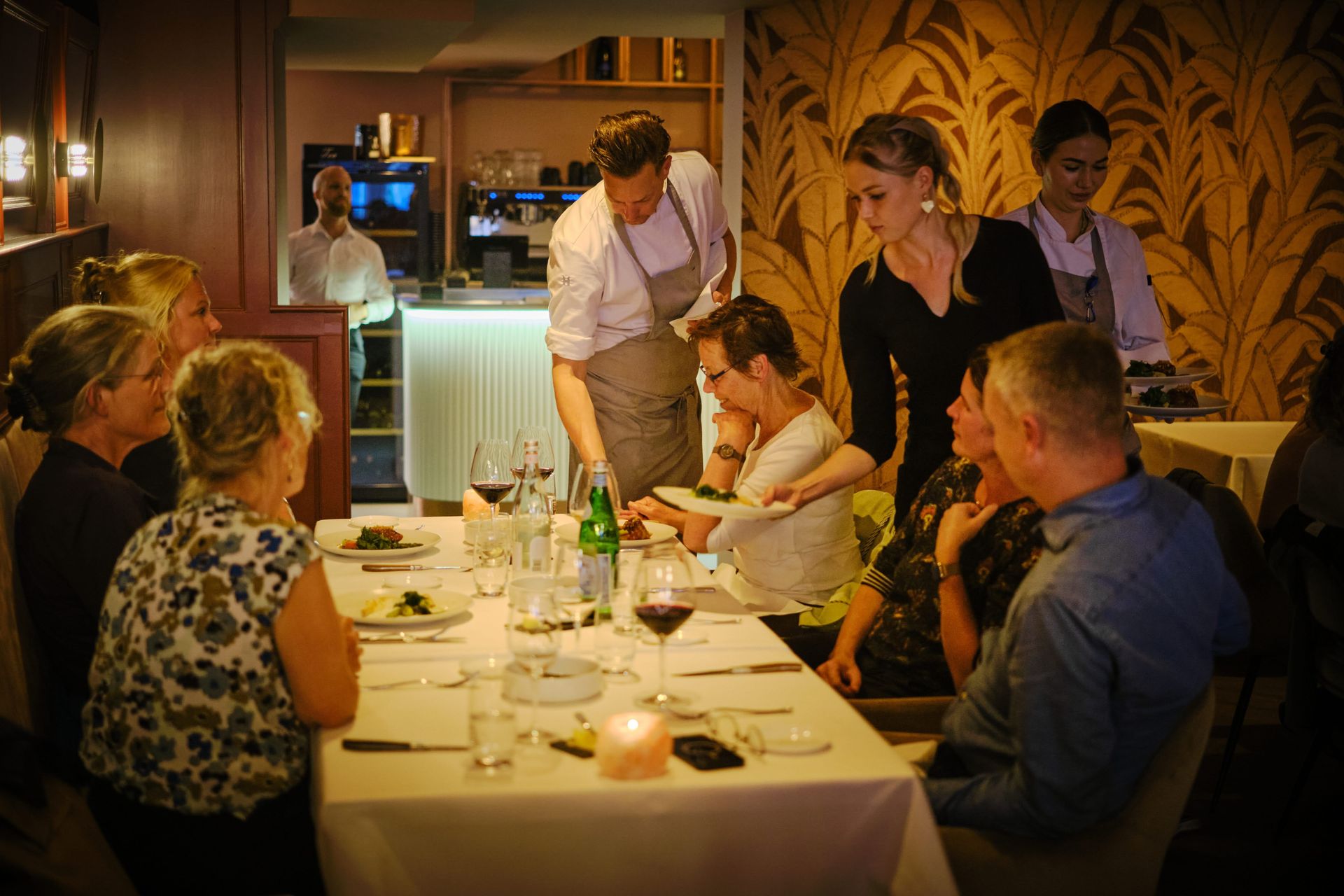 Een groep mensen zit aan een tafel in een restaurant