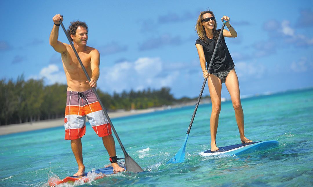 Couple paddleboarding in Mauritius