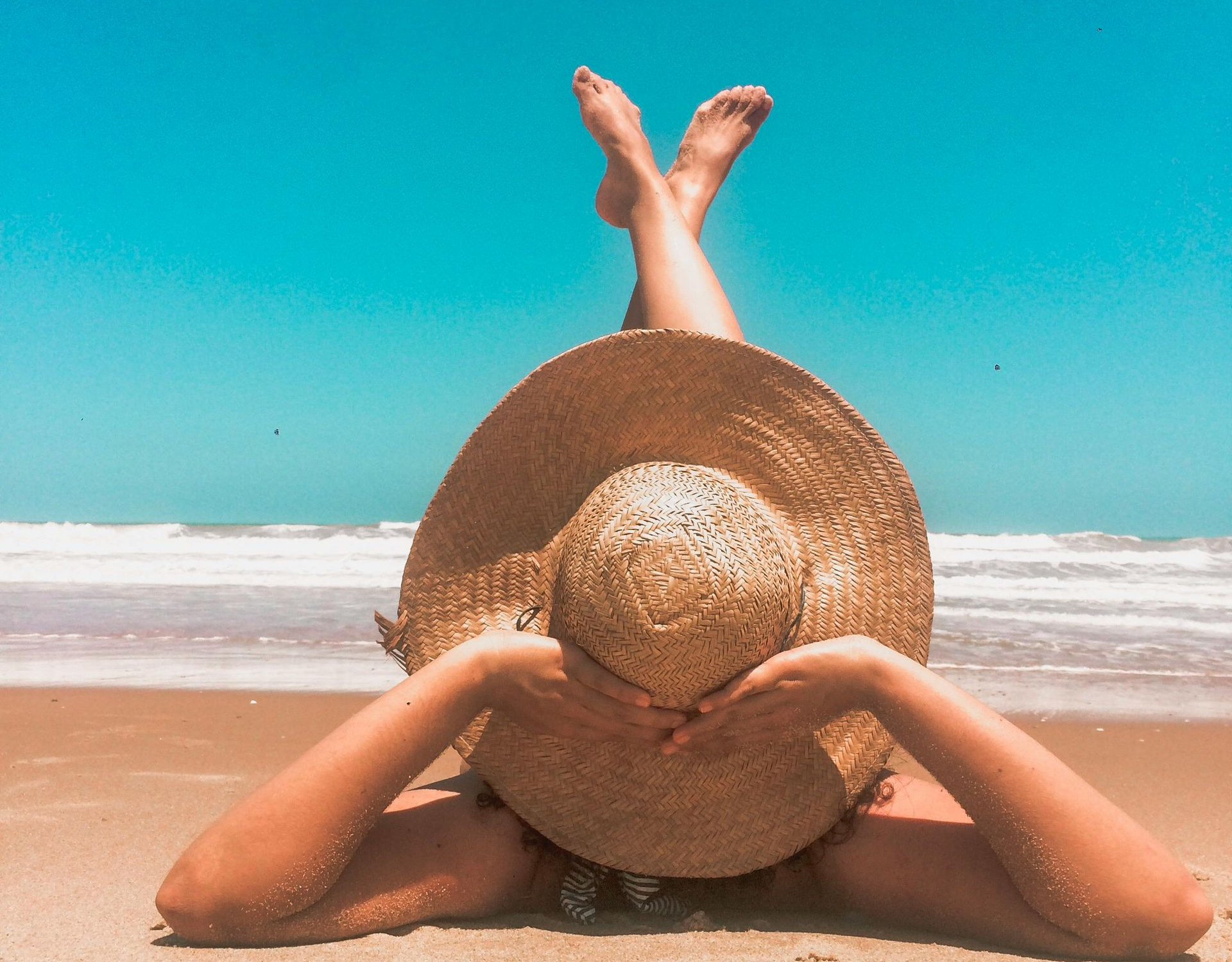 Sunglasses in sand, sunset in the background. Desert landscape, warm colors.