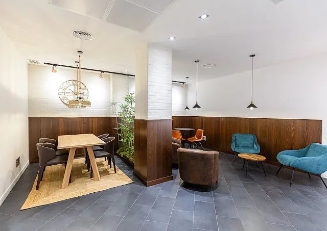 Hay una mesa y sillas en el medio de la habitación.