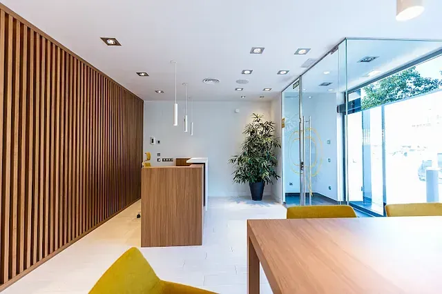 Una habitación con una mesa y sillas y un mostrador de madera.