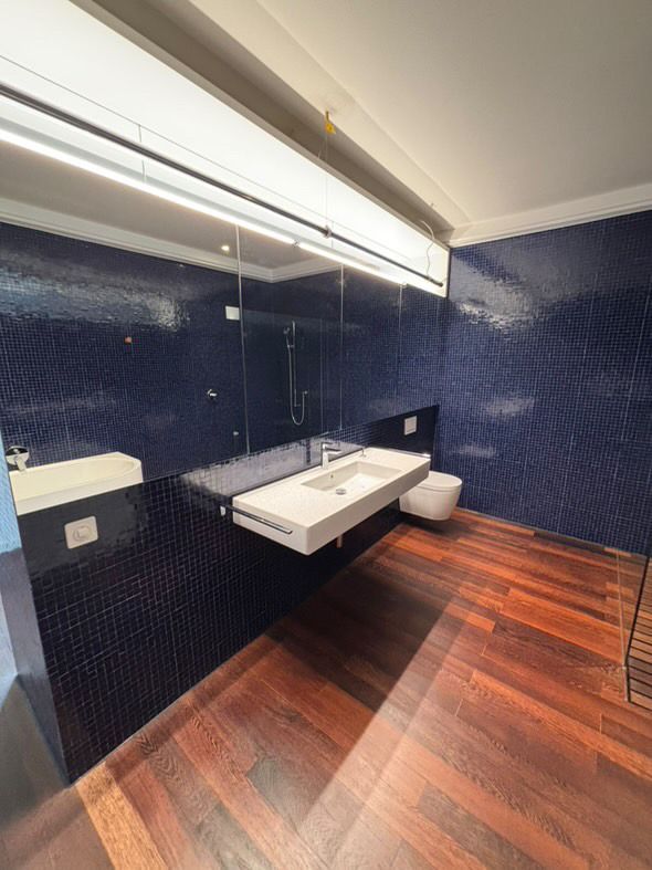 Ein Badezimmer mit Waschbecken, Toilette und Spiegel.