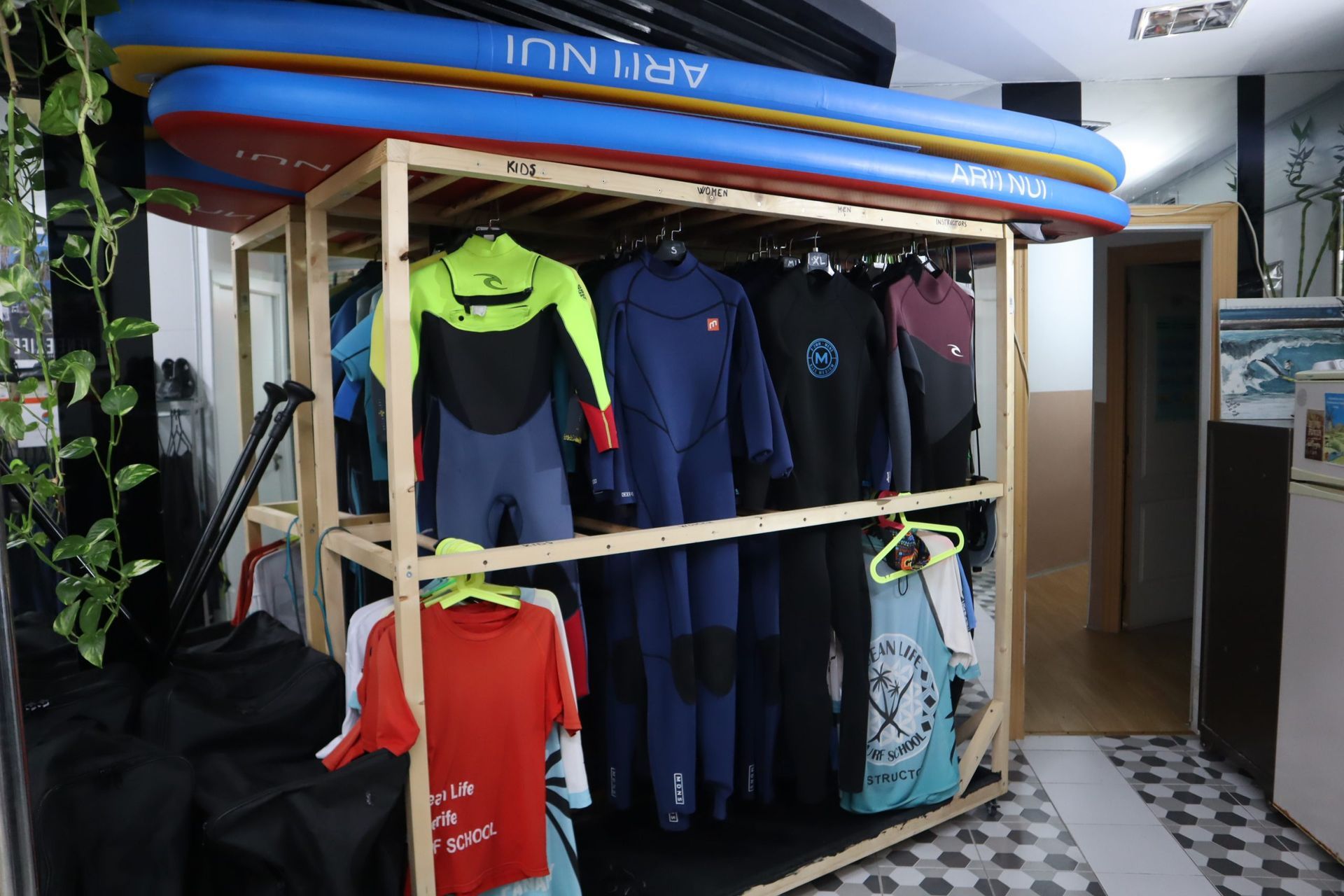 Una exhibición de trajes de neopreno y tablas de surf en una tienda