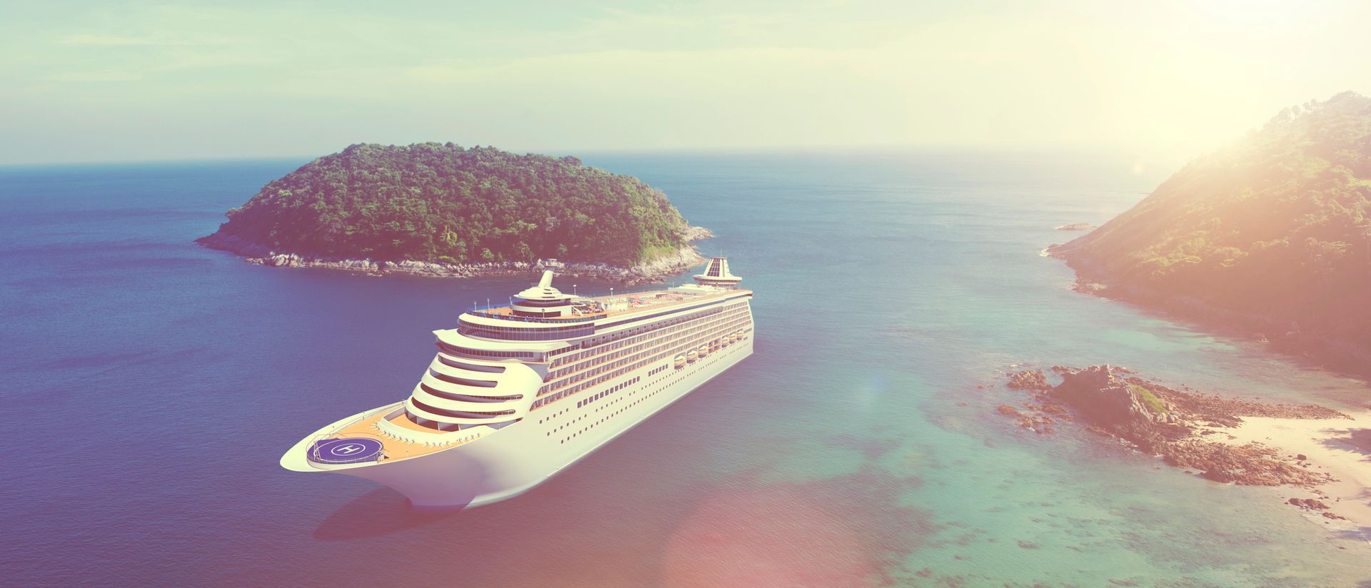 An aerial view of a cruise ship in the ocean near a small island.