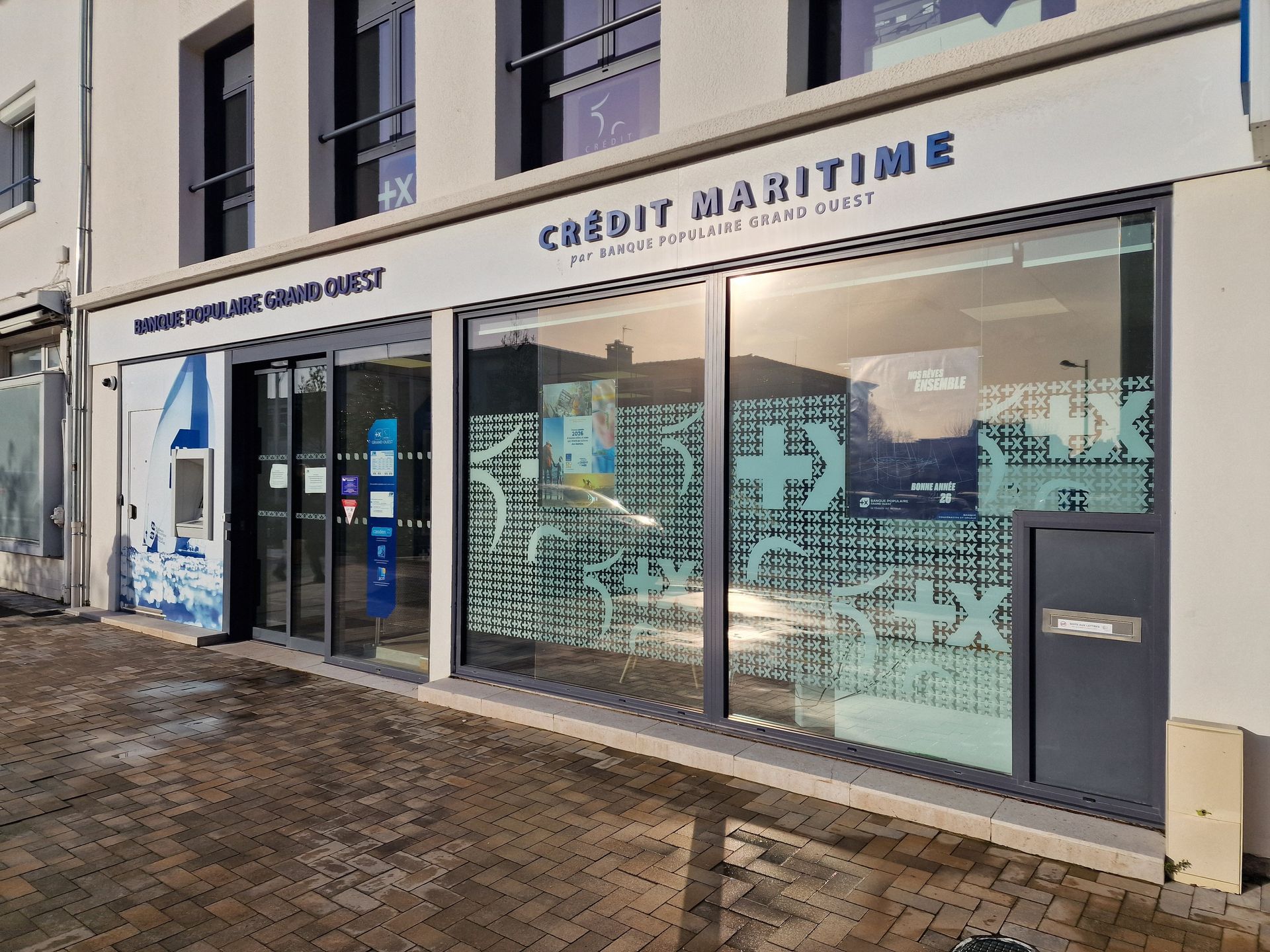 Façade d'une agence du Crédit maritime avec de grandes fenêtres.