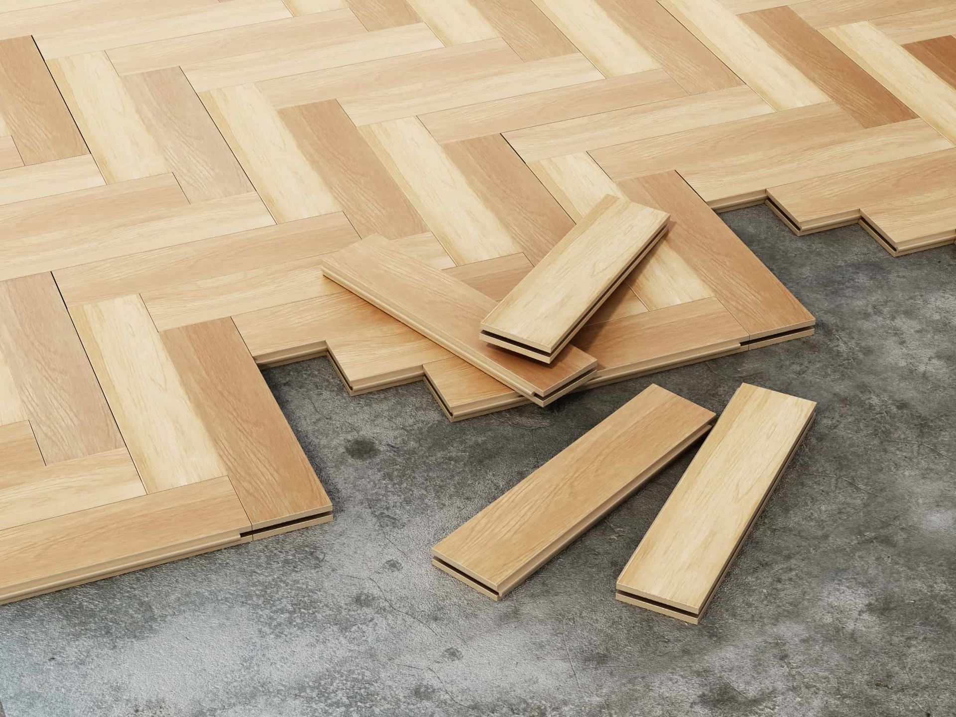 Instalación de suelo de madera en espiga con tablones individuales esparcidos sobre hormigón.