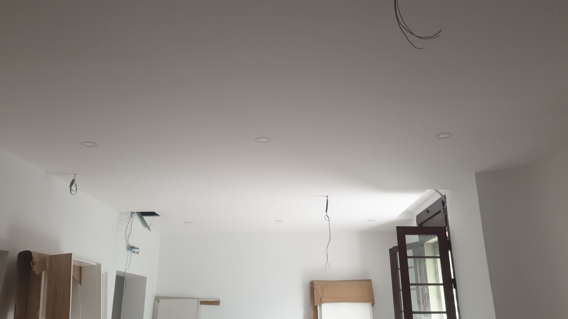 Una habitación con techo blanco y una ventana.