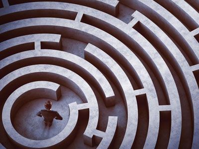 Un hombre está parado en medio de un laberinto.