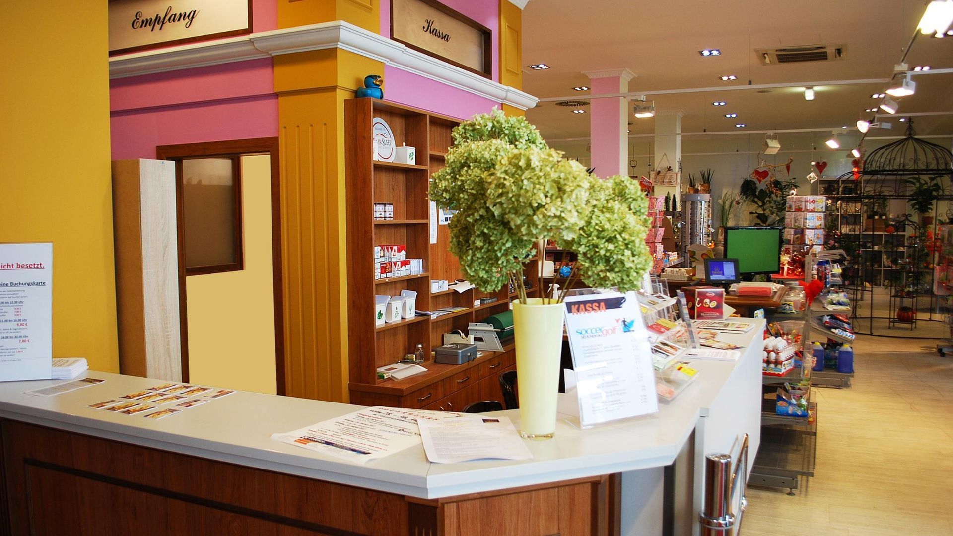 Boutique checkout counter with products, wood trim, and a store interior in the background