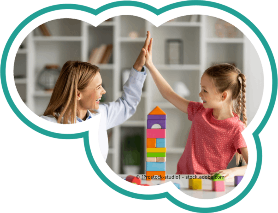 Eine Frau und ein kleines Mädchen geben sich beim Spielen mit Bauklötzen ein High Five.