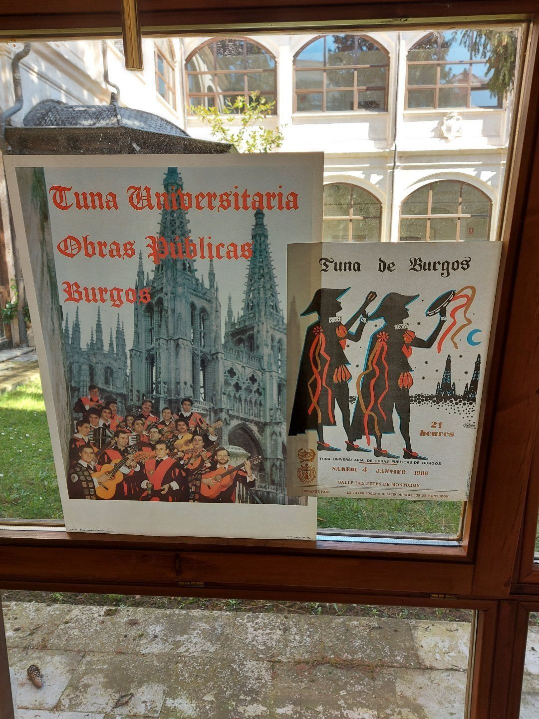 Two vintage posters in a window: 