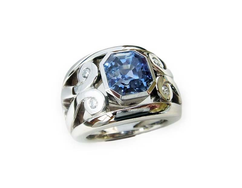 Silberring mit einem großen blauen Edelstein und kleinen Diamanten.