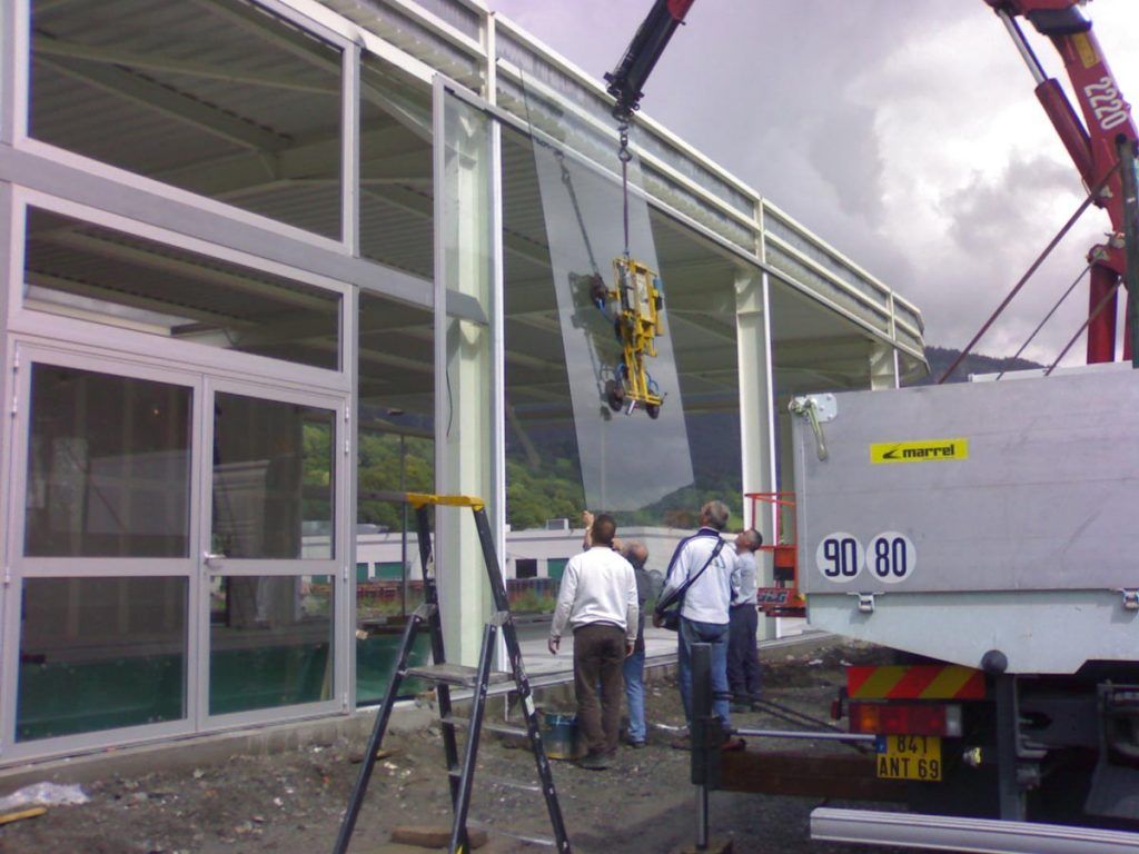 Des hommes installent une vitre