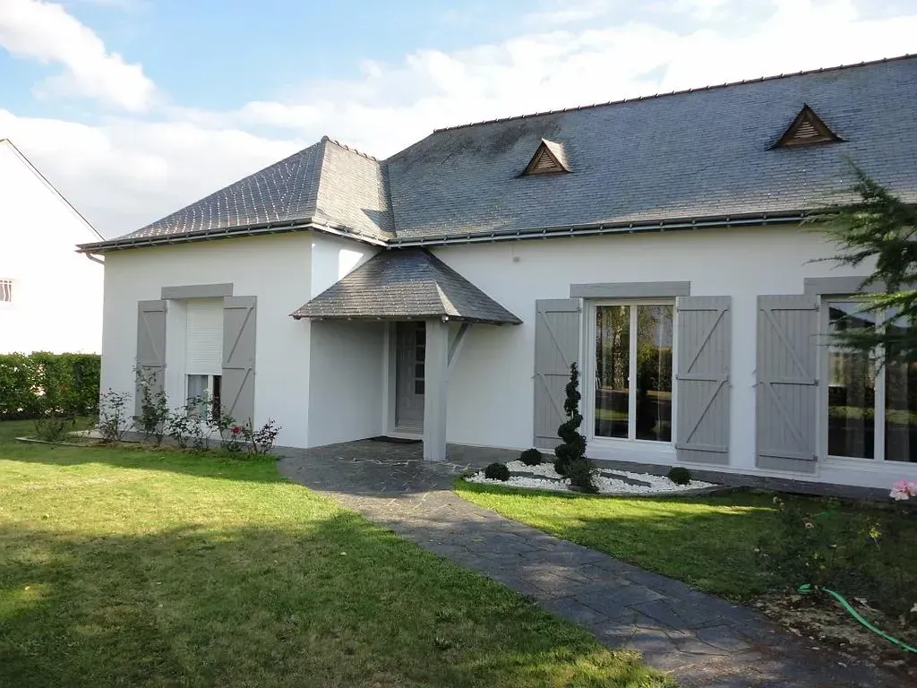 Maison blanche avec jardin devant