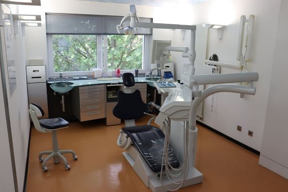 Mitarbeiter der Zahnarztpraxis Dr. med. Andreas Poetzsch untersucht Zähne einer Patientin