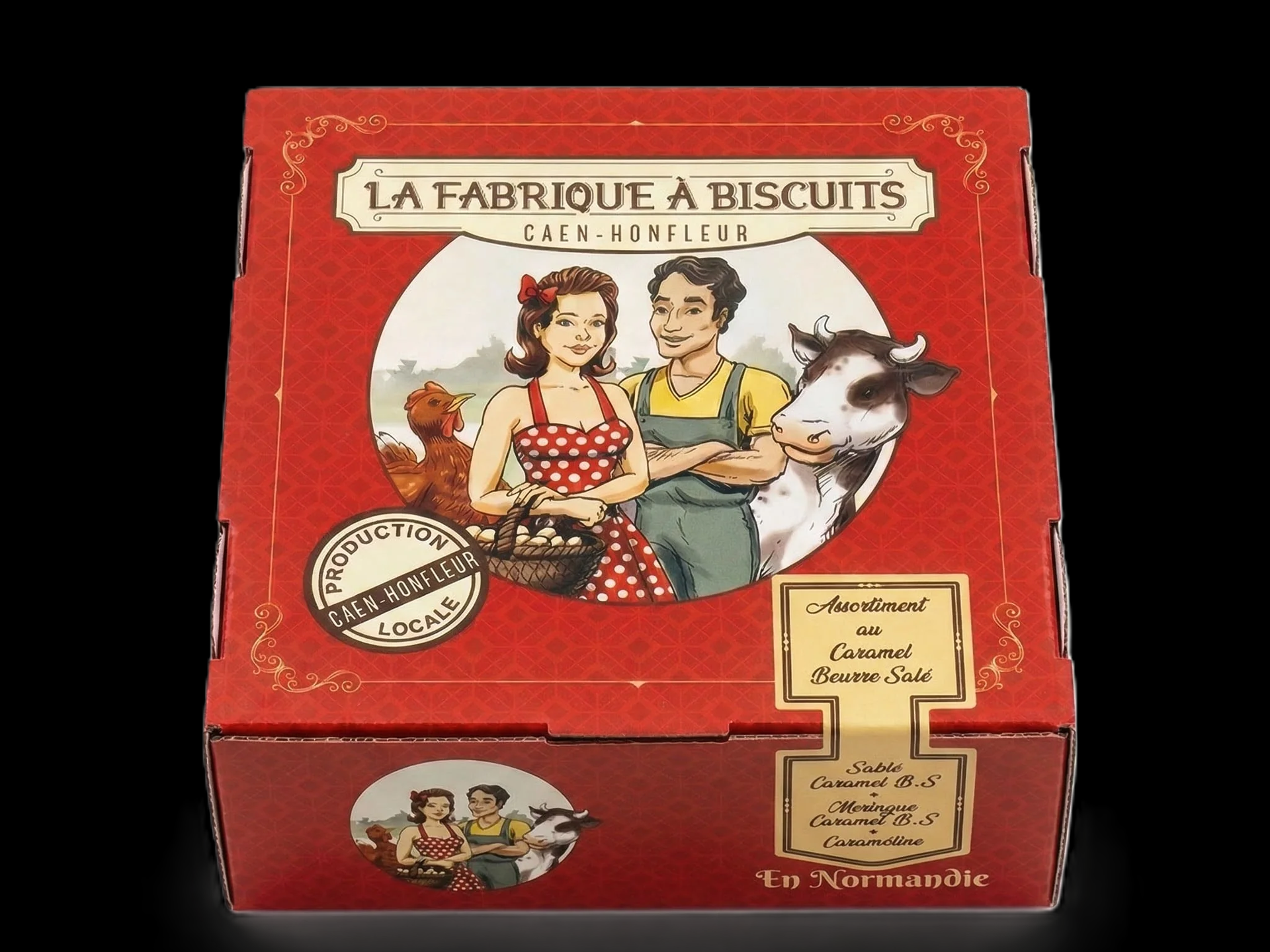 Boîte en métal La Fabrique à Biscuits avec une illustration vintage représentant deux boulangers et un chien.