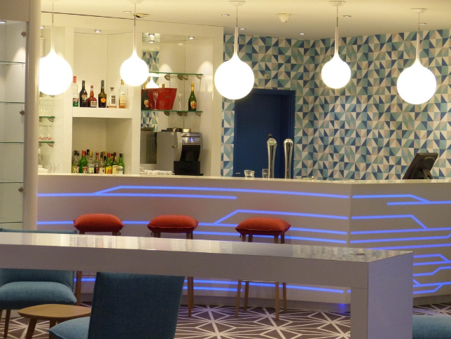 Un bar dans un restaurant avec un motif géométrique sur le mur