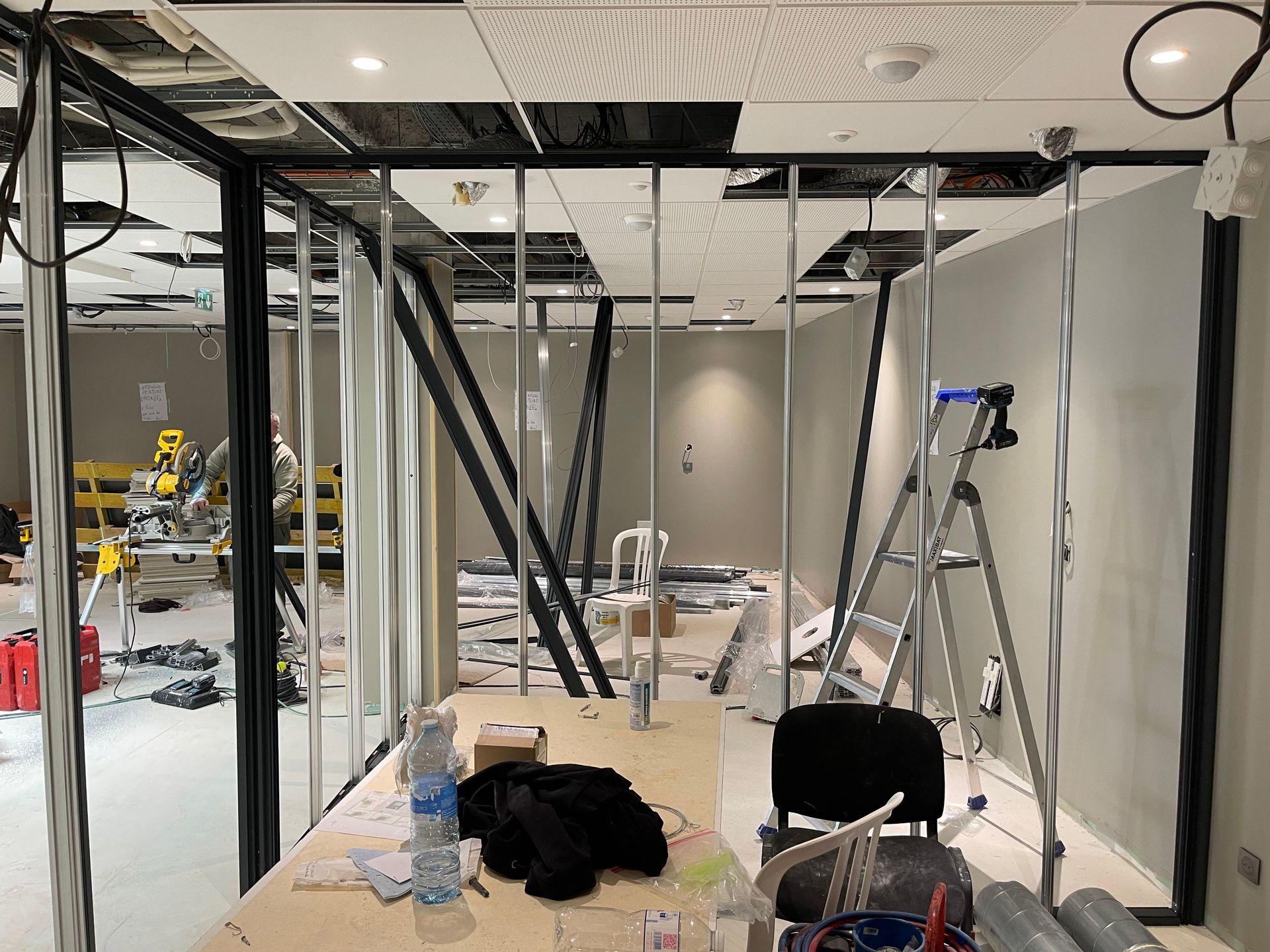 Chantier de construction intérieure : ossature métallique, cloisons partielles, plafond apparen