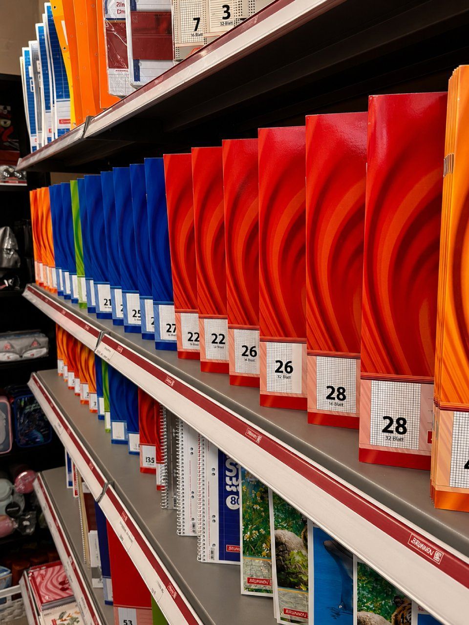 Regale in einem Ladengang, gefüllt mit farbenfroh verpackten Artikeln, beschriftet und ordentlich angeordnet