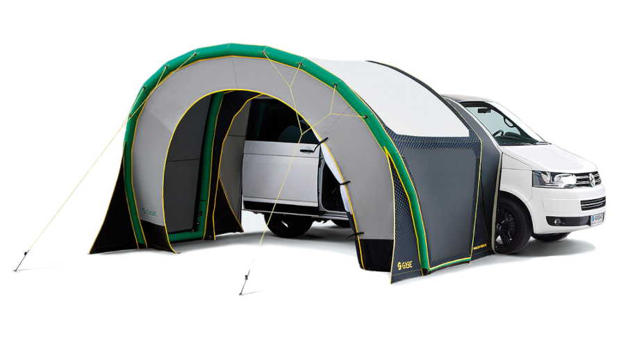 White car attached to a gray-green camping tent canopy, creating an outdoor shelter.