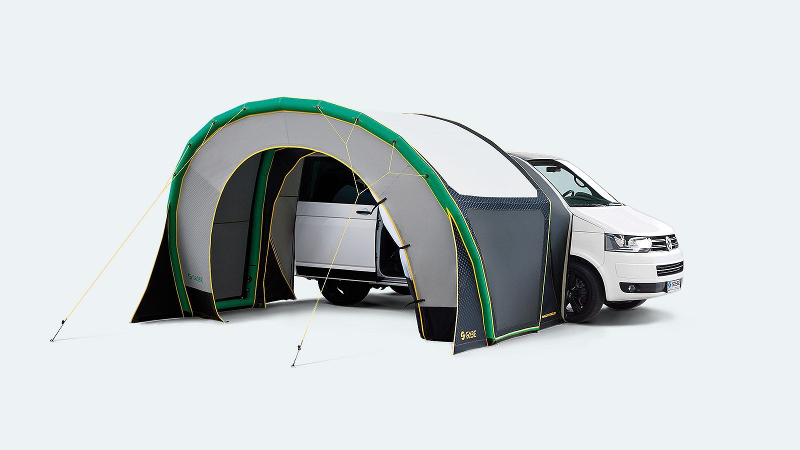 Portable tent shelter attached to a white SUV, with a person standing nearby inside the entrance