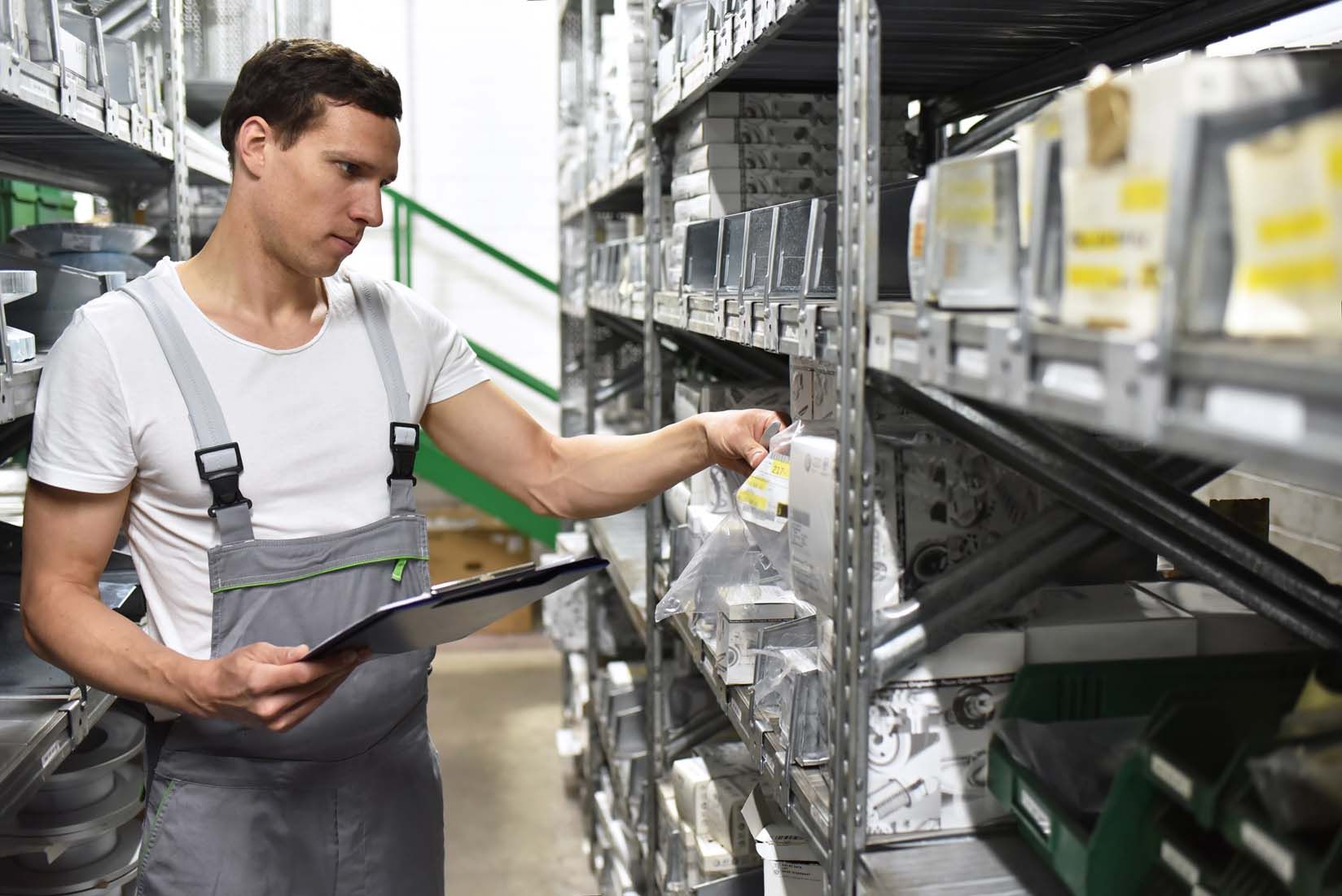 Professionnel inspectant des étagères à la recherche d'une pièce de rechange