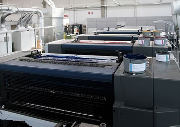 Una gran máquina de impresión se encuentra en un almacén.
